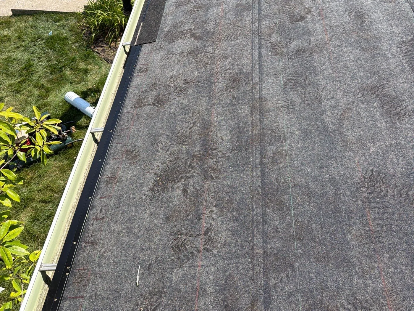 Ice and water shield covering the new roof deck, with chalk lines snapped for shingles