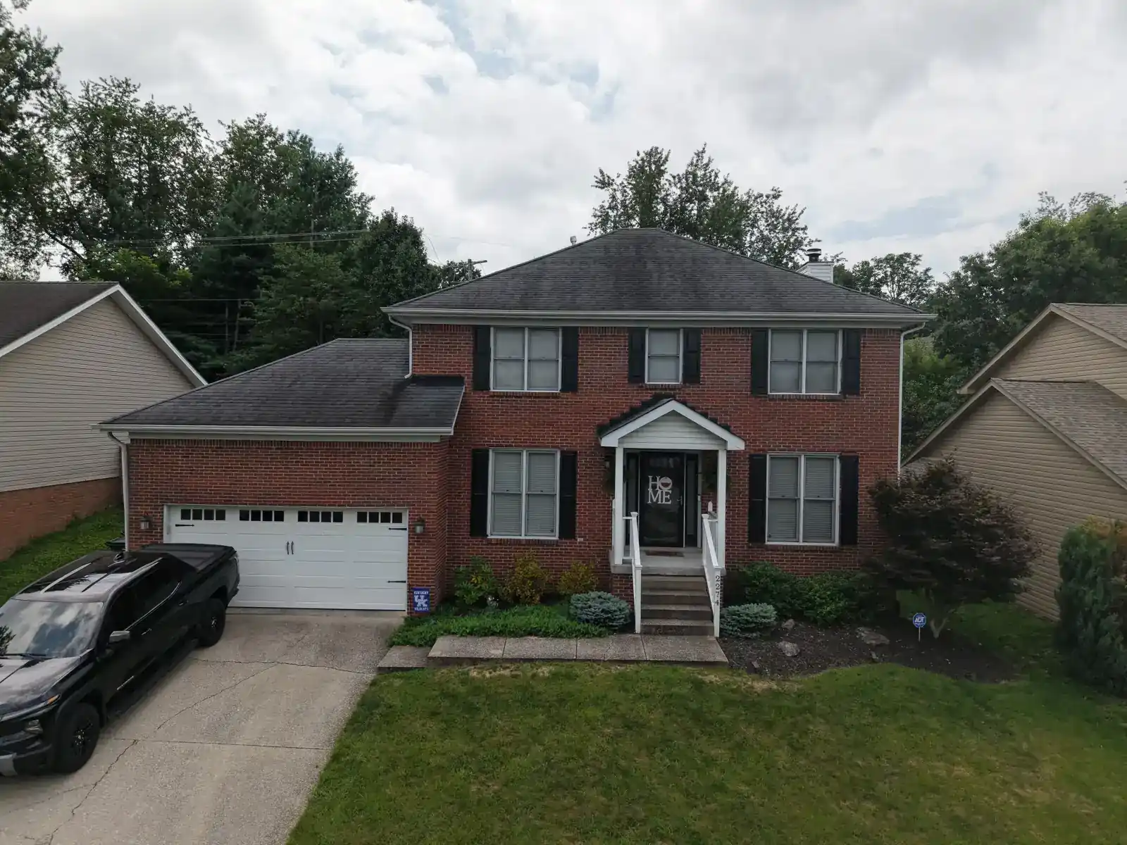Two-story brick home in Lexington before the new roof
