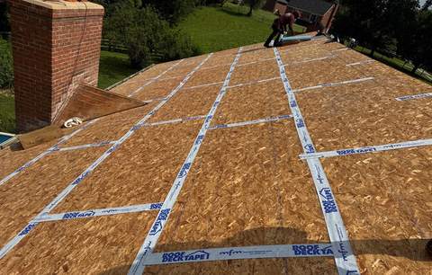 Bare roof deck in Burlington with tape over the seams between the deck sheets, before underlayment