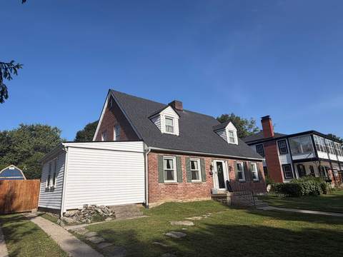 After: the same Cape Cod with a new charcoal roof