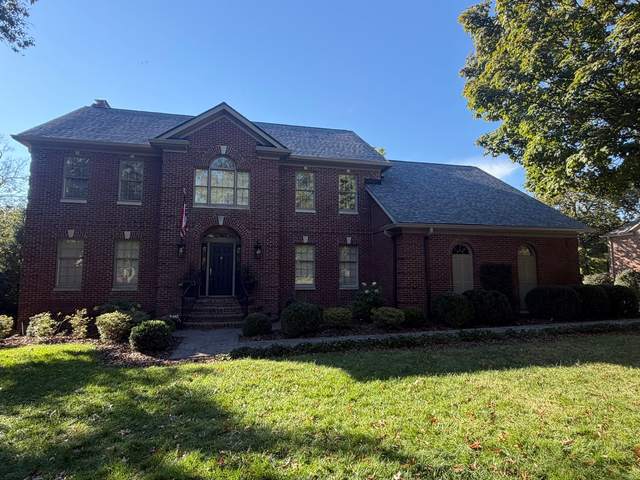 After: the same home from the front lawn with a new charcoal shingle roof