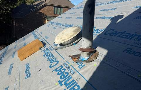 CertainTeed synthetic underlayment over the roof deck around a vent stack, before the shingles go on