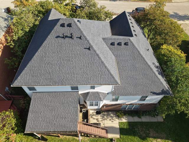 After: the same hip roof with new charcoal shingles