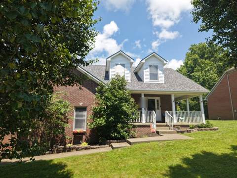 After: the same home from the front yard with its new gray roof