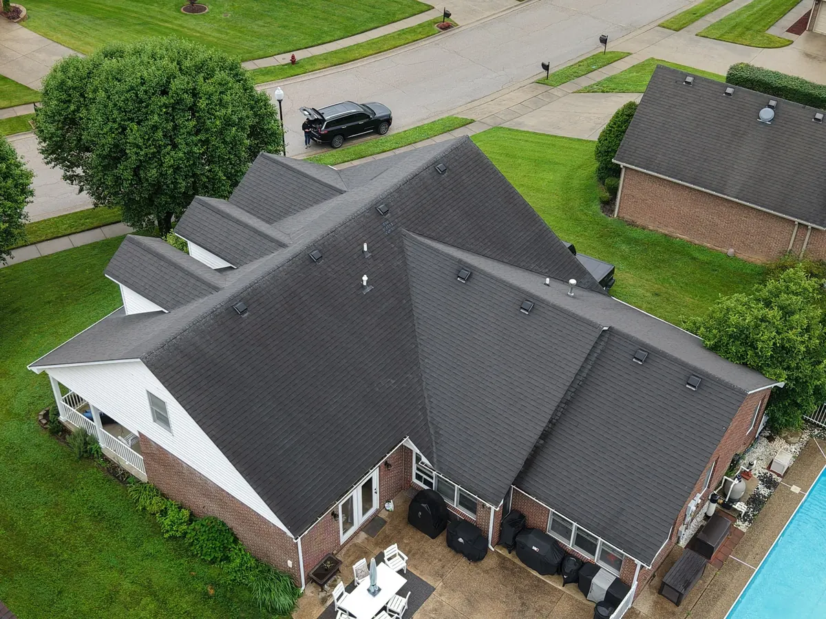 Before: aerial view of the same Richmond cape with worn dark shingles